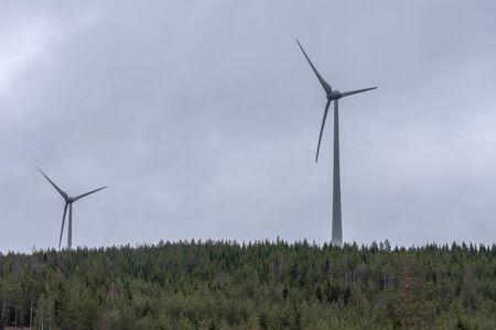 Wind power station - wind turbine against the cloudy sky. Spring Central Sweden. selective focus