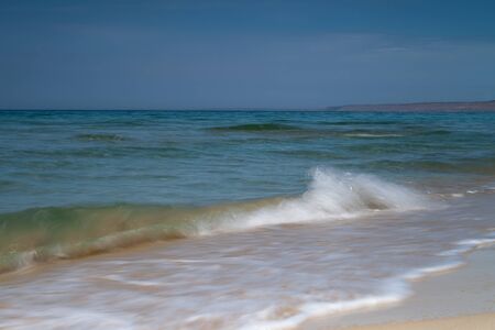 View of blue sea waves at sandy beach. Horizon line. Caspian Sea, sandstone coast. kazakhstan,...