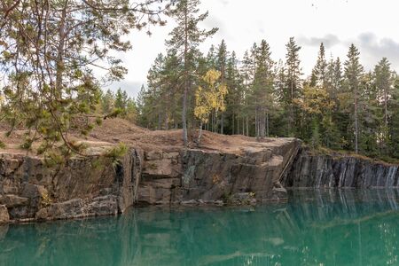 Old abandoned silver mine with blue, emerald water on a sunny evening. silverberg in central Sweden. selective focusの写真素材