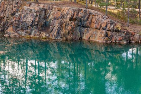 Old abandoned silver mine with blue, emerald water on a sunny evening. silverberg in central Sweden. selective focusの写真素材