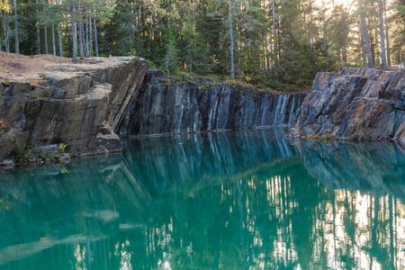 Old abandoned silver mine with blue, emerald water on a sunny evening. silverberg in central Sweden. selective focusの写真素材
