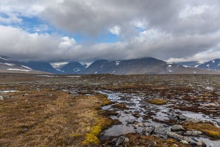 Beautiful wild nature of Sarek national park in Sweden Lapland with snow capped mountain peaks,...