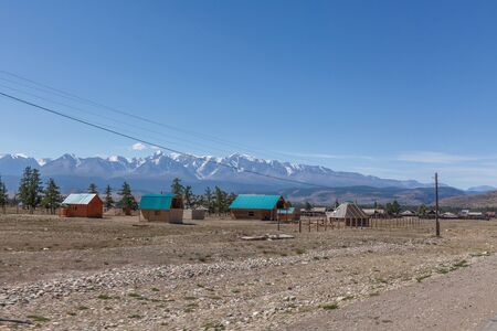 Village at the foot of Belukha Mountain. Altai Russia. Belukha the highest peak of Siberiaの写真素材