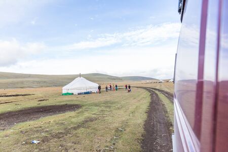 Altai, Mongolia - A small settlement of the nomadic people of Mongolia. Children welcome tourists traveling by car.の写真素材