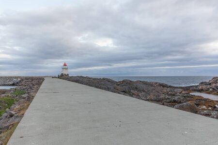 Lighthouse in Norwegian fjords, Norway. Sea mountain landscape view.の写真素材