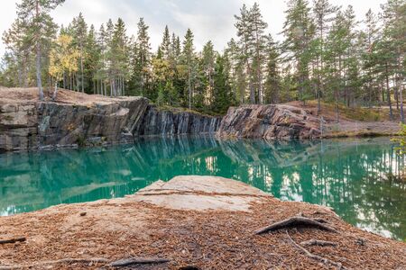 Old abandoned silver mine with blue, emerald water on a sunny evening. silverberg in central Sweden....