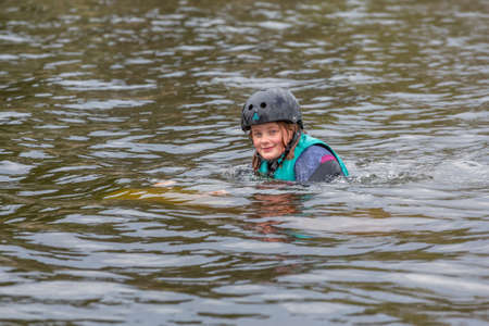 Fagersta, Sweden - Maj 07, 2020: Girl teenager wakeboarder fells into the water after an unsuccessful jumpのeditorial素材