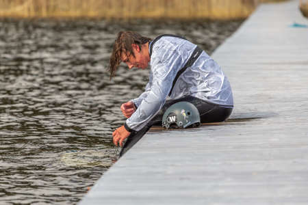 Fagersta, Sweden - Maj 01, 2020: Teenager wakeboarding on a lake.のeditorial素材