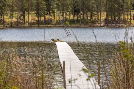 Wooden pier on the lake in central Swedenの写真素材