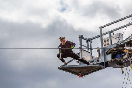 Fagersta, Sweden - Maj 22, 2020: A young girl is repairing a cable car.