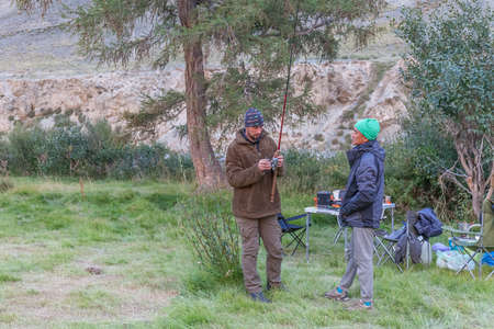 Altai, Mongolia - June 14, 2017: Fishermen are preparing a fishing rod.のeditorial素材