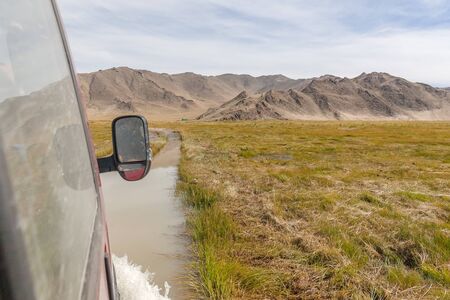 Journey of river on SUV car. Mongolia - Altai. photo made from inside carの写真素材