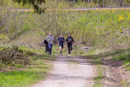 Fagersta, Sweden - Maj 18, 2020: Teenagers run in the park at a physical education lesson.のeditorial素材