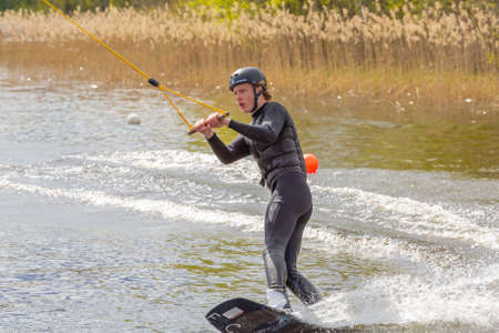 Fagersta, Sweden - Maj 18, 2020: Teenager boy wakeboarders on a lake during a physical education lessonのeditorial素材