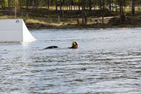 Fagersta, Sweden - Maj 26, 2020: Wakeboarding. Girl wakeboarder falls into the water after an unsuccessful jumpのeditorial素材