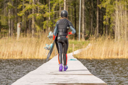 Fagersta, Sweden - Maj 07, 2020: Teen girl wakeboarder goes on the pier