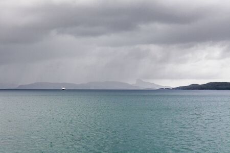 Beautiful view of the Norwegian fjords with turquoise water surrounded by cloudy sky, selective focusの写真素材