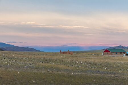 a small Mongolian settlement in the mountains of Altai at sunsetの写真素材