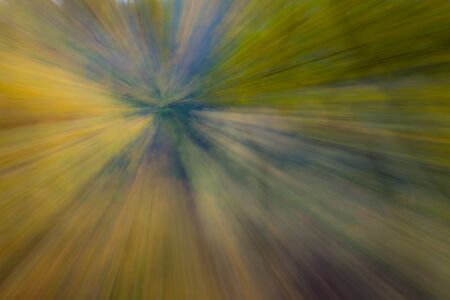 Abstract photo, forest in autumn photographed with different effects of motion and zoom. Colorful textured background. long shutter speed.の写真素材