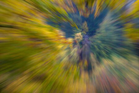 Abstract photo, forest in autumn photographed with different effects of motion and zoom. Colorful textured background. long shutter speed.の写真素材