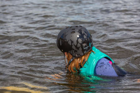 Fagersta, Sweden - Maj 26, 2020: Wakeboarding. Girl wakeboarder fell into the water after an unsuccessful jump.のeditorial素材