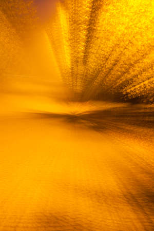 Abstract photo, Alley in the autumn park. photographed with different effects of motion and zoom. Colorful textured background. long shutter speed.の写真素材