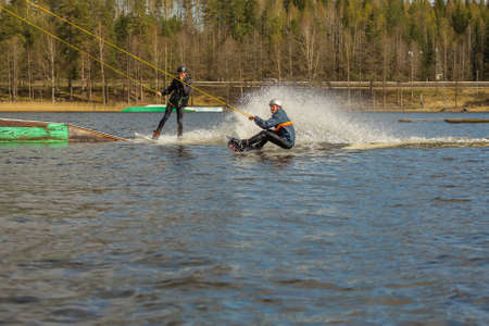 Fagersta, Sweden - Maj 01, 2020: Two teenagers wakeboarders on a lake during a physical education lesson.のeditorial素材
