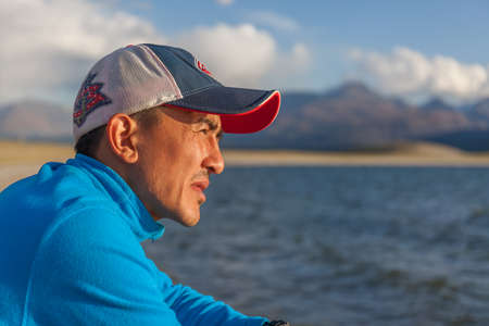 Altai, Mongolia - June 14, 2017: guy on the shore of a mountain lake.のeditorial素材