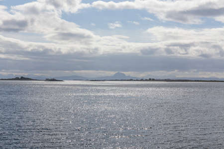 Beautiful view of the Norwegian fjords with turquoise water surrounded by cloudy sky, selective focusの写真素材