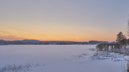 Sunset at the frozen lakeの写真素材