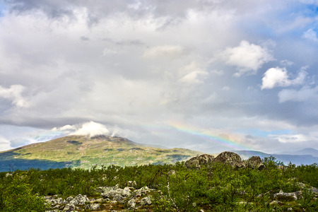 Rainbow over mountain in Lofoten Norwayの写真素材