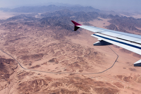 View to the Earth from a window of 10,000 metres flying at height above sea level the airplane Desert, mountains, Sinai Peninsulaの写真素材