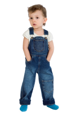 A little boy standing in a denim suit on a white backgroundの写真素材