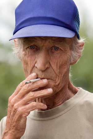 Harmful habit at elderly men - smokingの写真素材