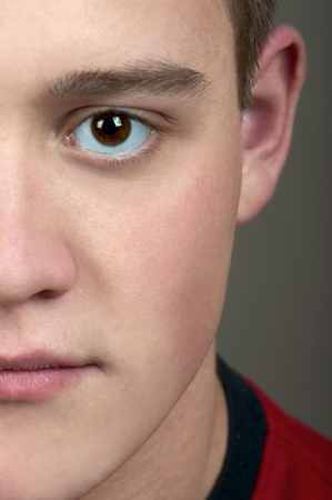 Half face of young man looking at youの写真素材