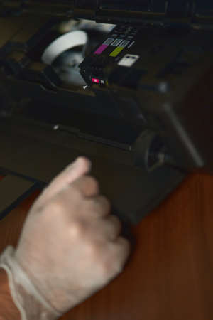 The printer is checked by a technician.