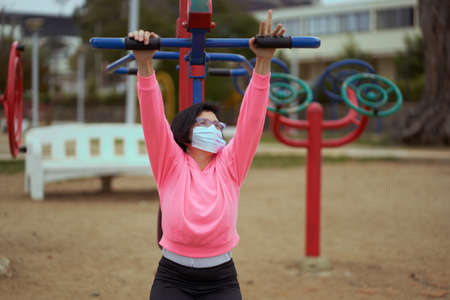 New normality. woman with mask or mask mask and sportswear. woman exercises in the park. Sport sessionの写真素材