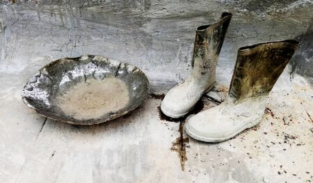 Gumboots and Equipment in construction areaの写真素材