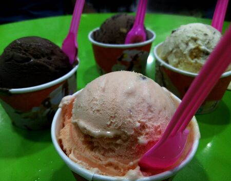 Ice cream scoop on a green tableの写真素材