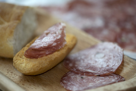 fast snack with delicacy with toast and salami