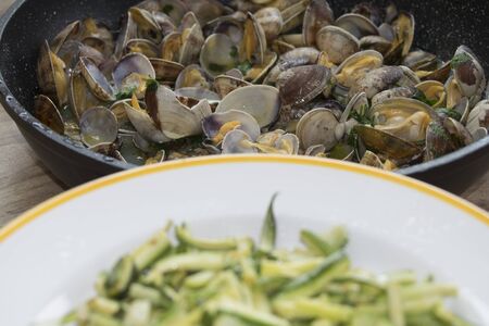 condiment for pasta: zucchini and clamsの写真素材