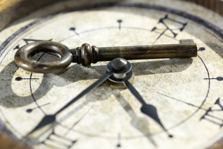 concept of the key of the past with a key and an old watchの写真素材