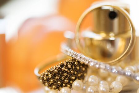 Charm and fashion: wedding ring and other jewels on colored soap