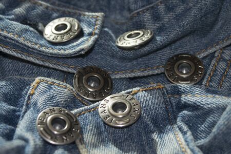 Metallic button in sequence  of a jacket jeans