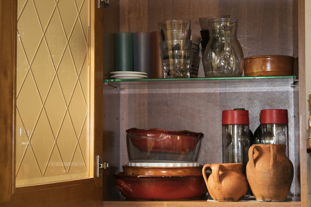 interior of cupboard with glasses and objects of cuisineの写真素材