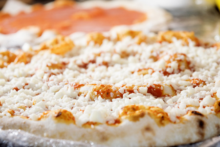 neapolitan pizza with mozzarella and tomato sauce just taked out of the ovenの写真素材