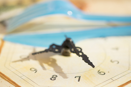 lunch time concept with a clock and colored cutleriesの写真素材
