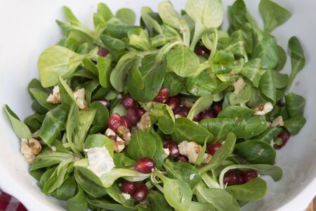 healthy salad of grapes of pomegranate valerian and kernel walnutsの写真素材