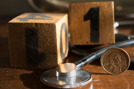 concept of health and economy with a stethoscope and one dollar