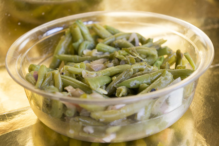 french beans stir-fried with bacon and served on a glass bowl